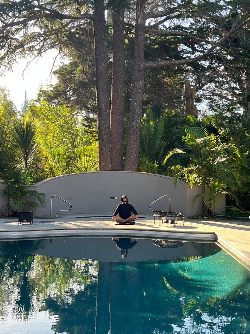 Seated meditation by a pool